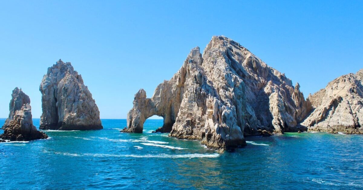 Scenic,View,Of,Large,Rocks,In,The,Water,With,Arch Scenic,View,Of,Large,Rocks,In,The,Water,With,Arch