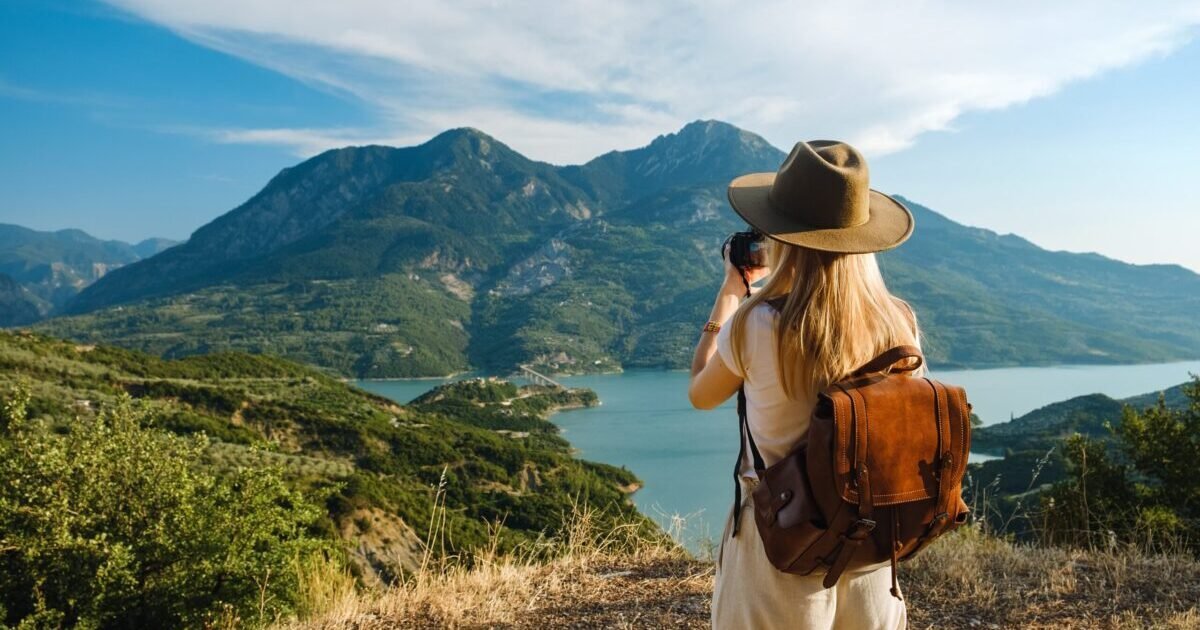 Woman,Photographer,With,Big,Backpack,Taking,Photo,Of,Mountains,And Woman,Photographer,With,Big,Backpack,Taking,Photo,Of,Mountains,And